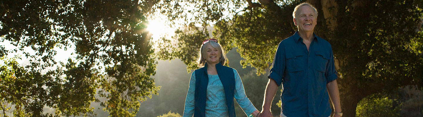 A senior couple holding hands during morning walk